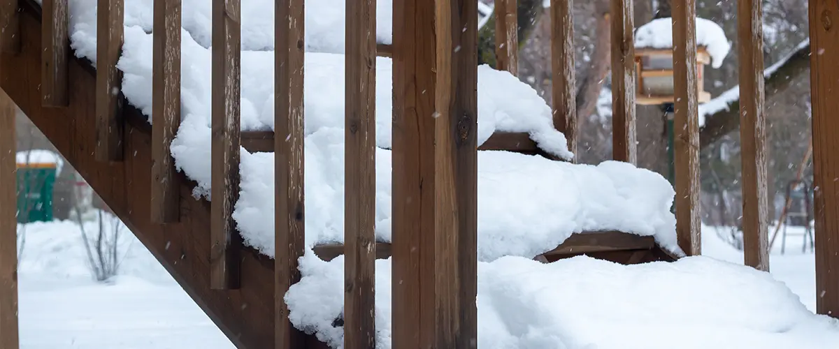 Deck stairs covered in snow