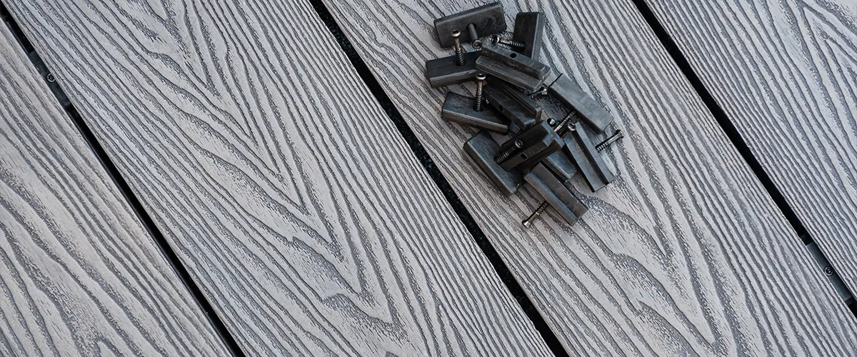 Dark composite decking with natural wood grain and fasteners