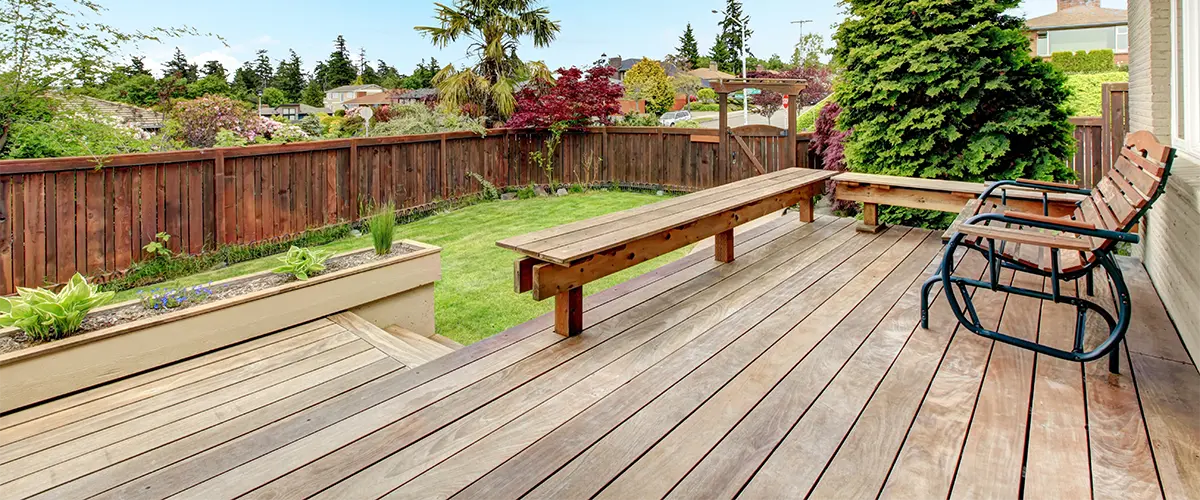 Deck building companies in Bellevue that built a hardwood deck with a wood chair