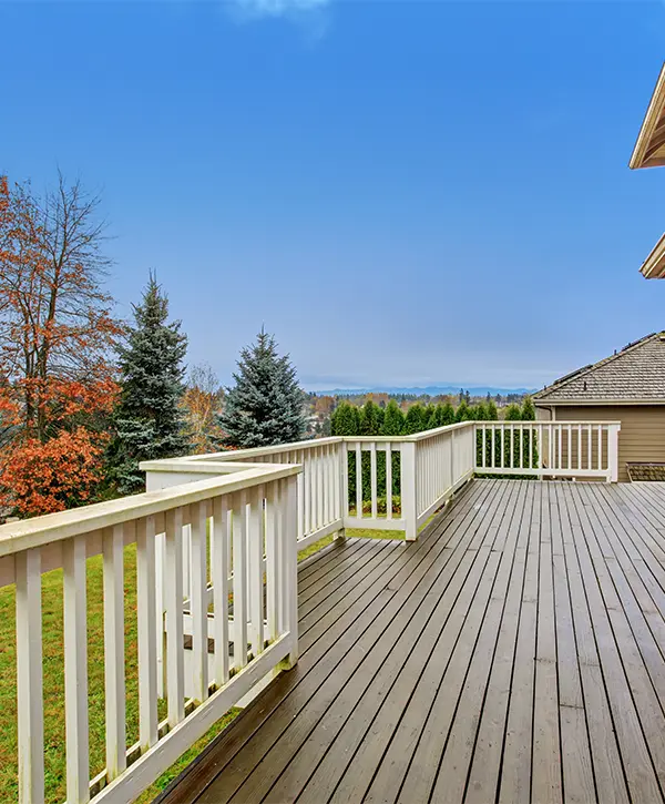 White railing on wood decking stained brown