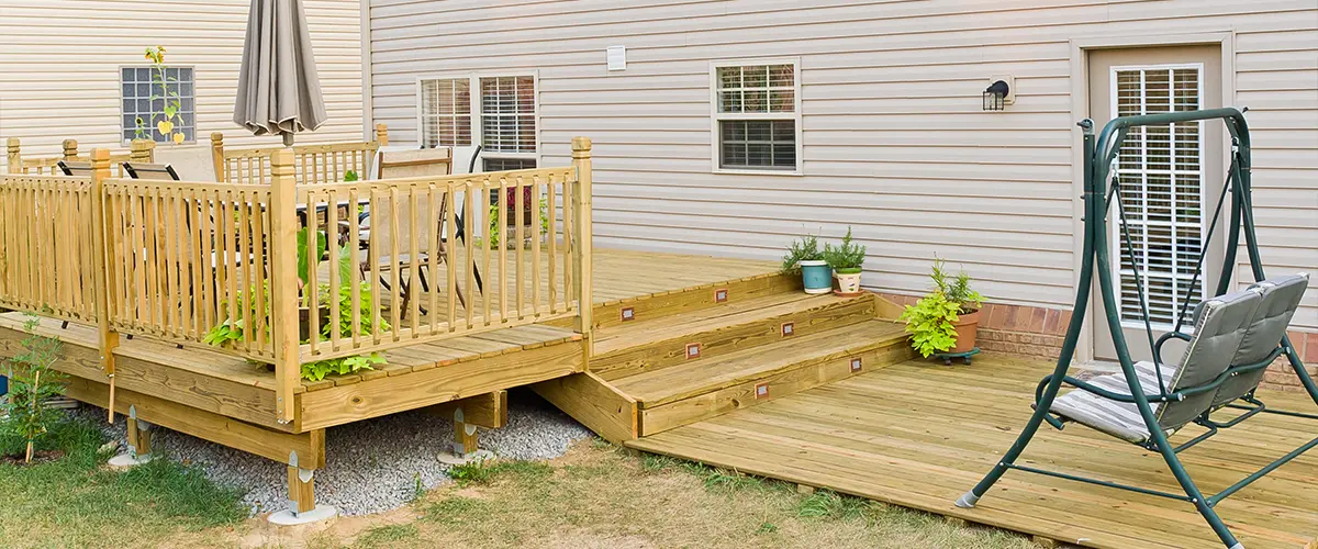 A pressure-treated deck with a swinger and stairs light