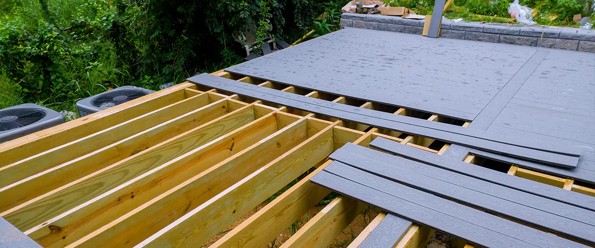 Composite decking being installed on a deck with wood frame