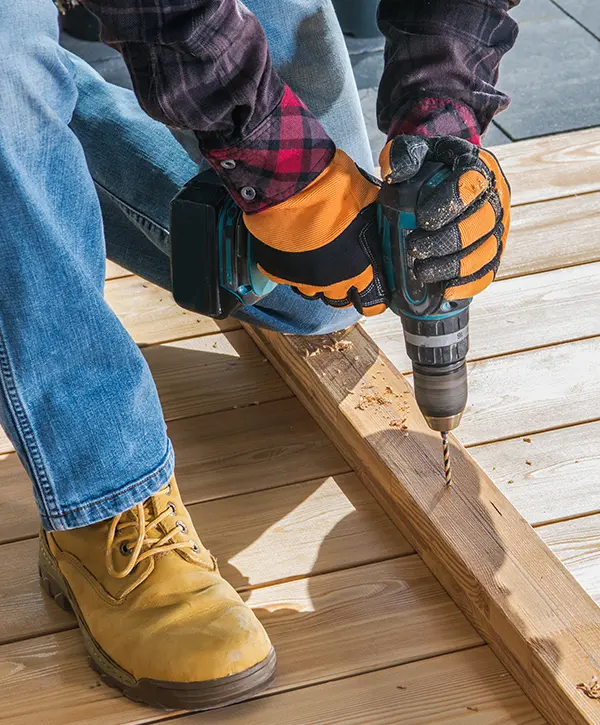 A contractor repairing a deck in Fremont