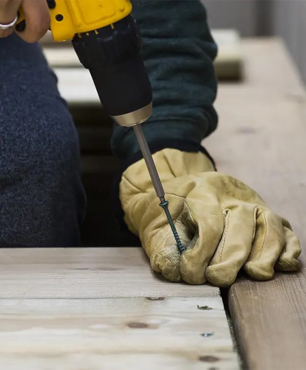 A contractor working on a deck building in Valley, NE