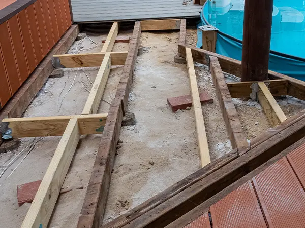 A deck frame repair with blocks and pressure treated wood