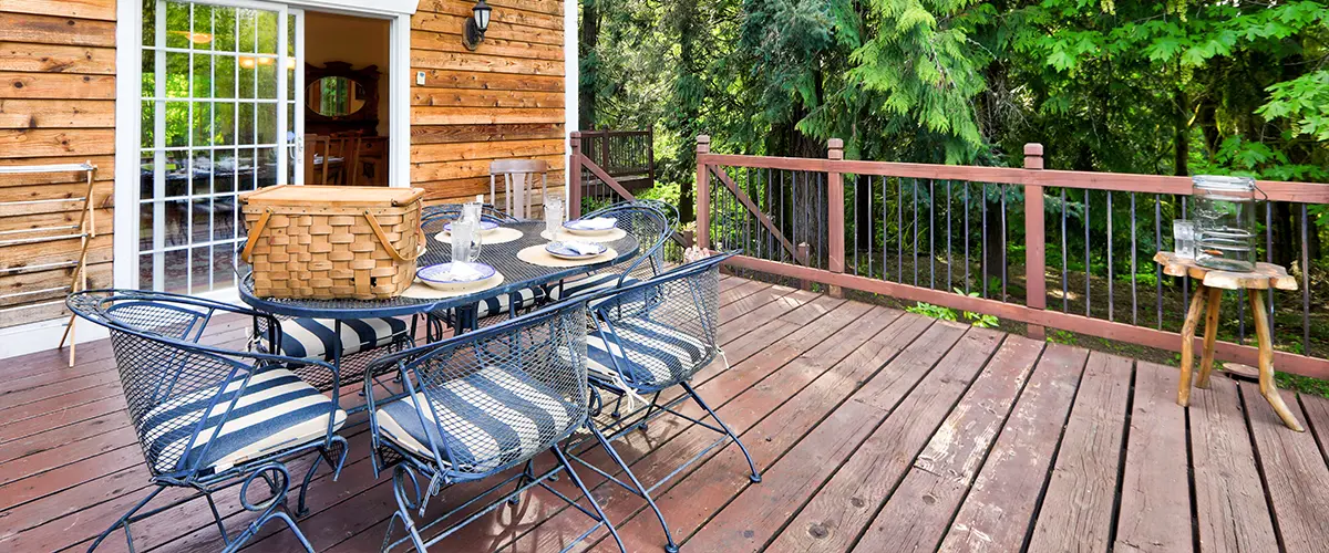 A faded wood decking with outdoor furniture