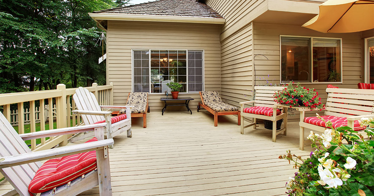 A wood deck with outdoor furniture and plants built by one of the best deck repair companies in Bellevue