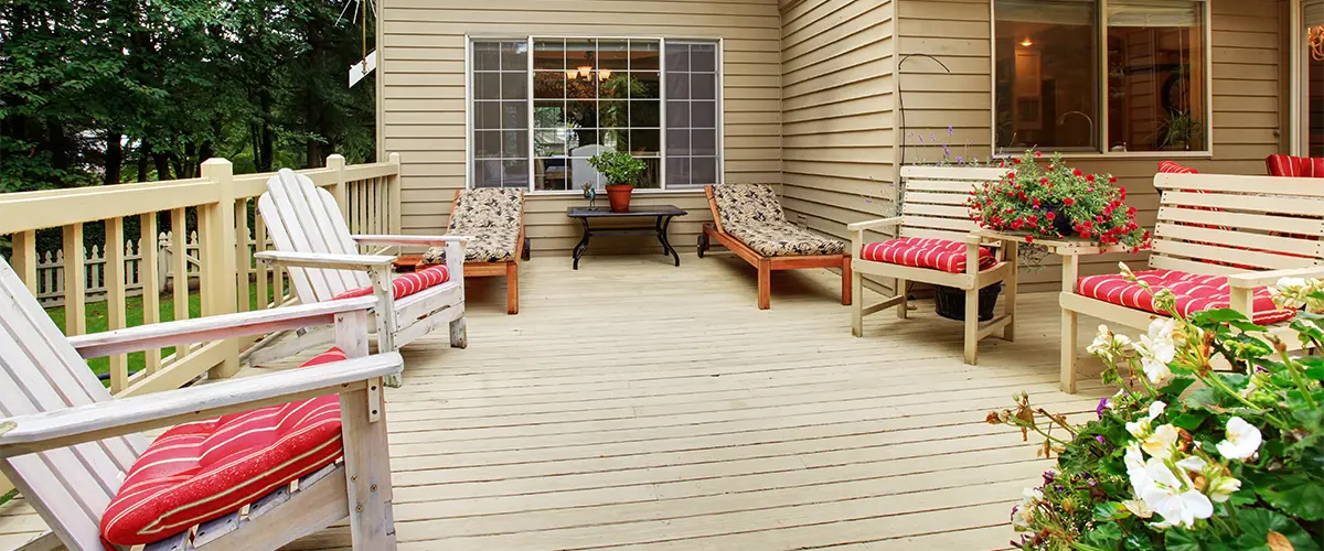 A wood deck with outdoor furniture and plants built by one of the best deck repair companies in Bellevue