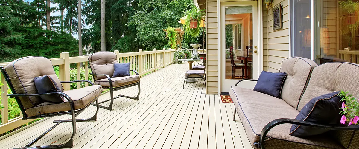 A deck repair cost of a wooden decking with beige stain and outdoor furniture