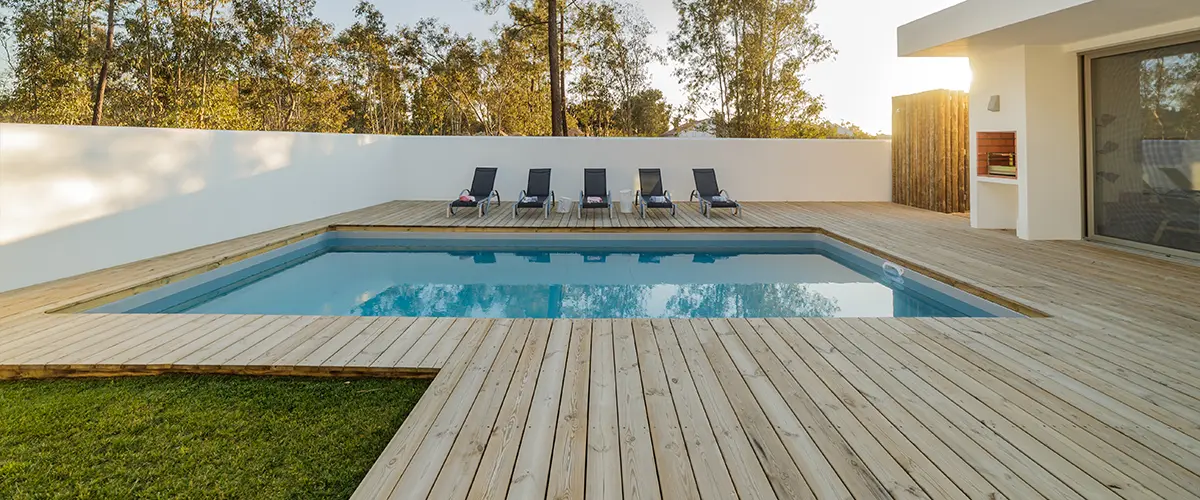 Wood decking around a pool in a backyard