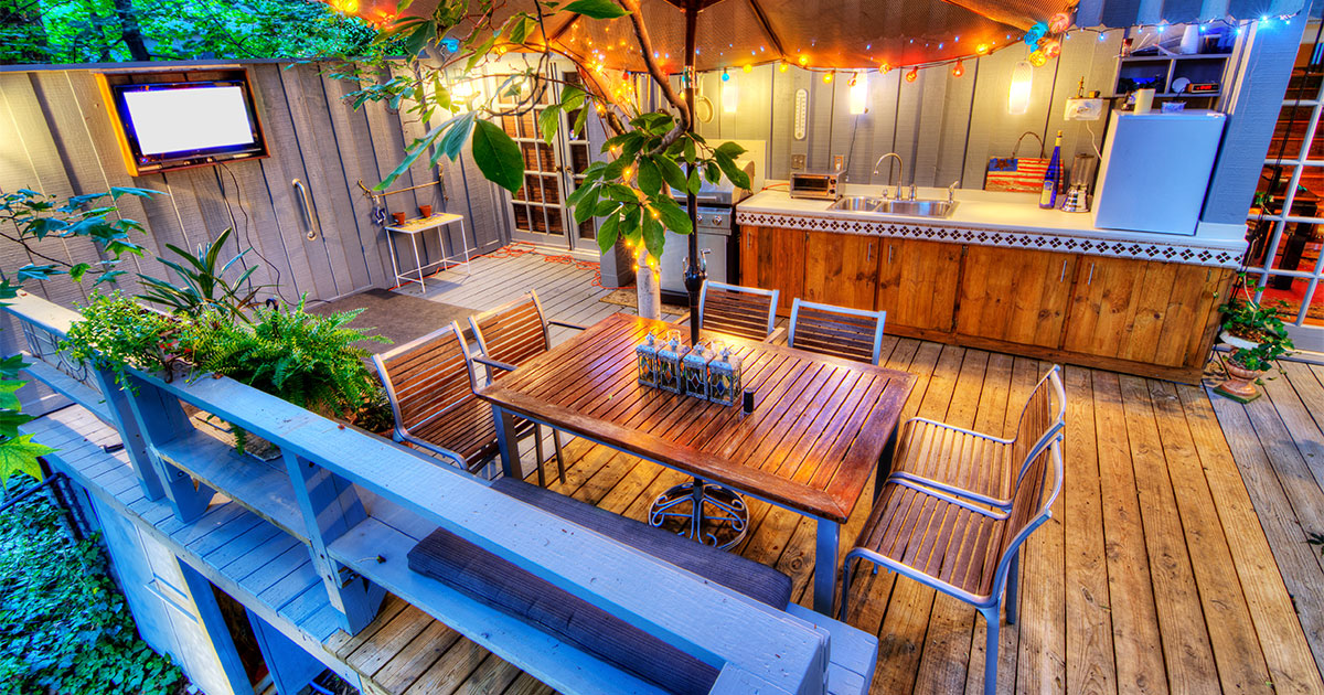 A deck that holds a lot of weight from an outdoor kitchenette and a bar