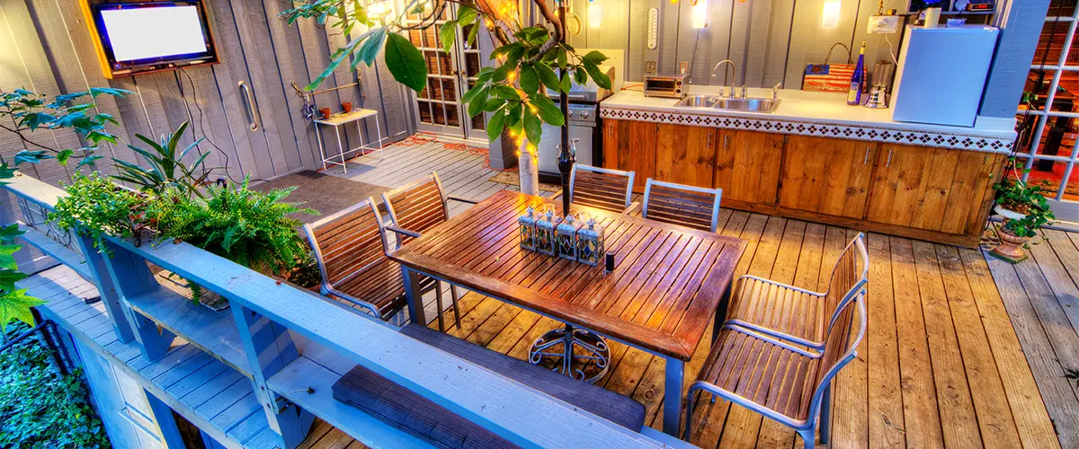 A wood deck with a kitchenette and a bar