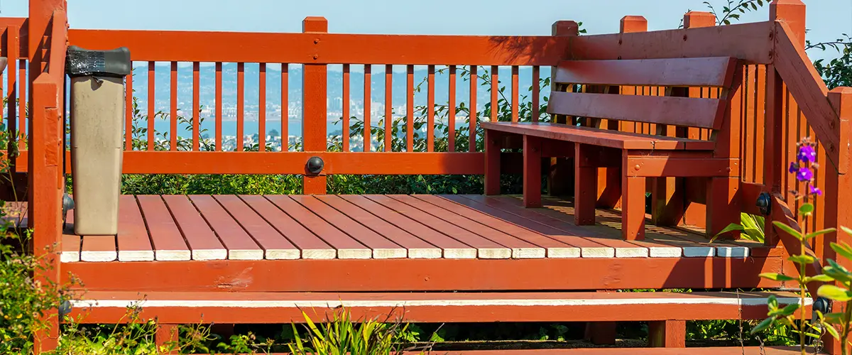 Redwood decking with railing and a built-in bench