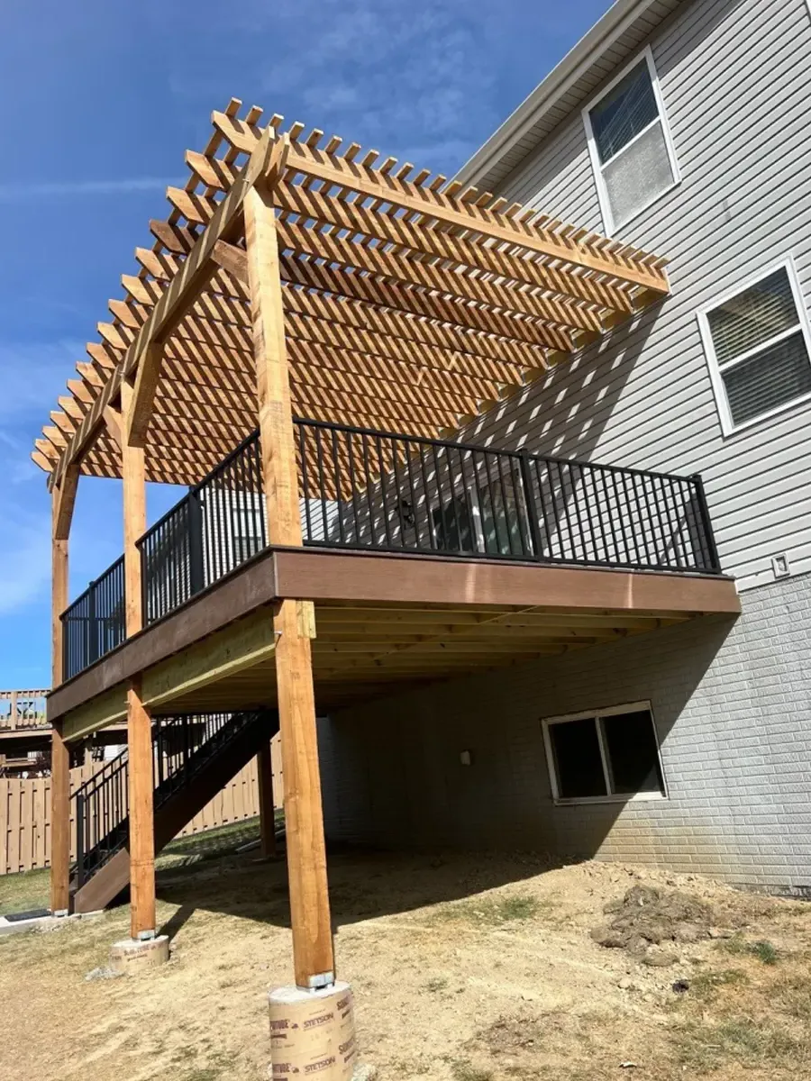 Raised composite deck with shading pergola in Omaha by Deck Bros