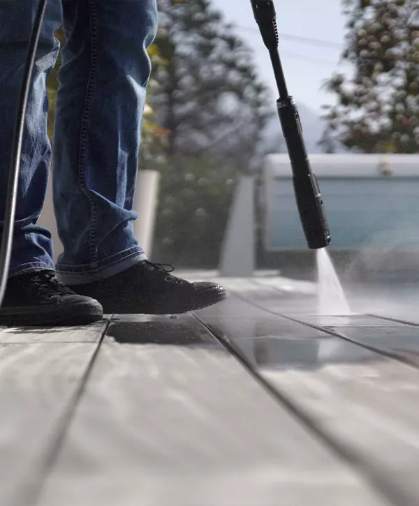 Man using high pressure washer for deck cleaning in Omaha