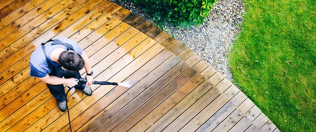 high water pressure cleaner on wooden terrace surface