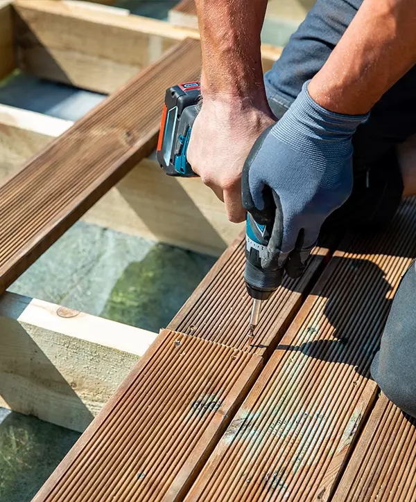 Deck Repair, builder installing impregnated wooden boards