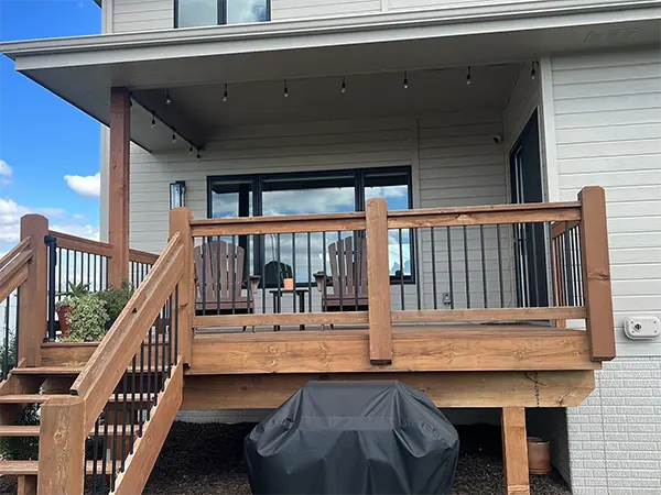 Modern deck installation with ambient lighting and comfortable seating.