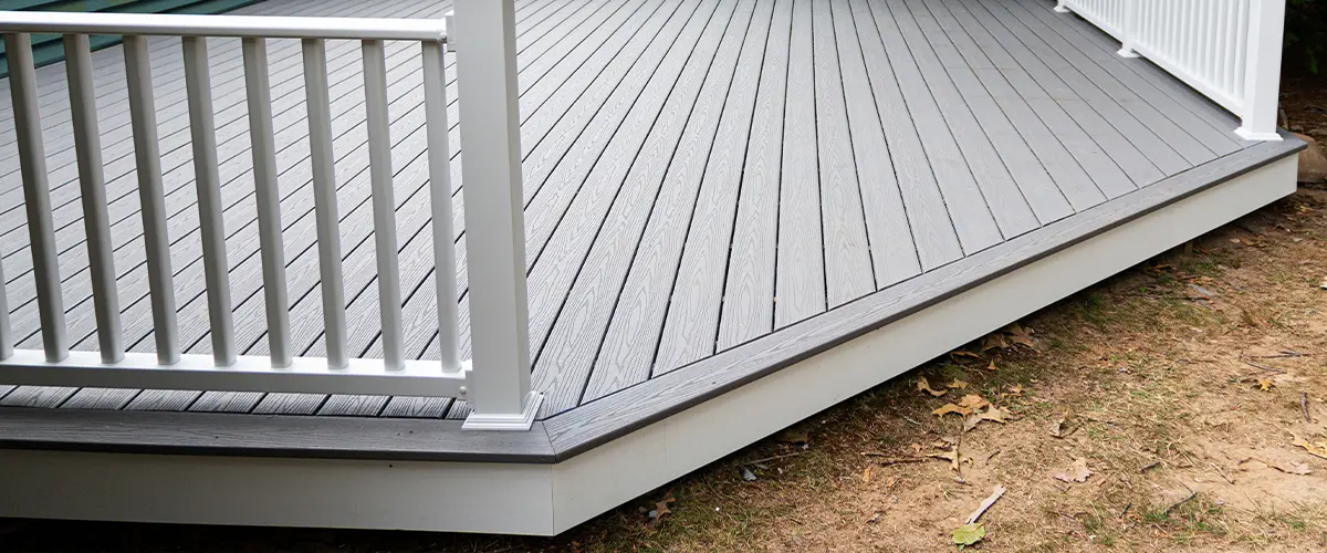 Quality deck fascia installation in Omaha with grey composite design and white railings.