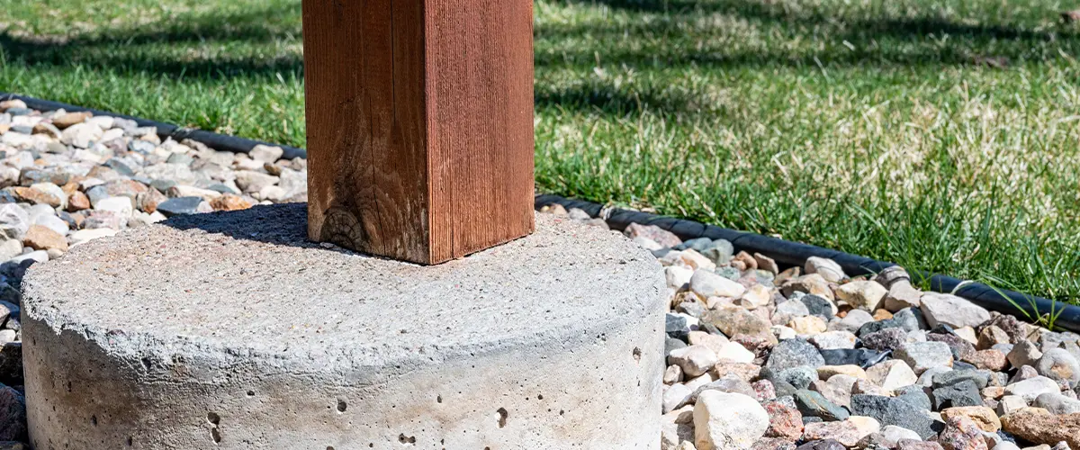 Wooden deck support free-standing on a concrete tube footing