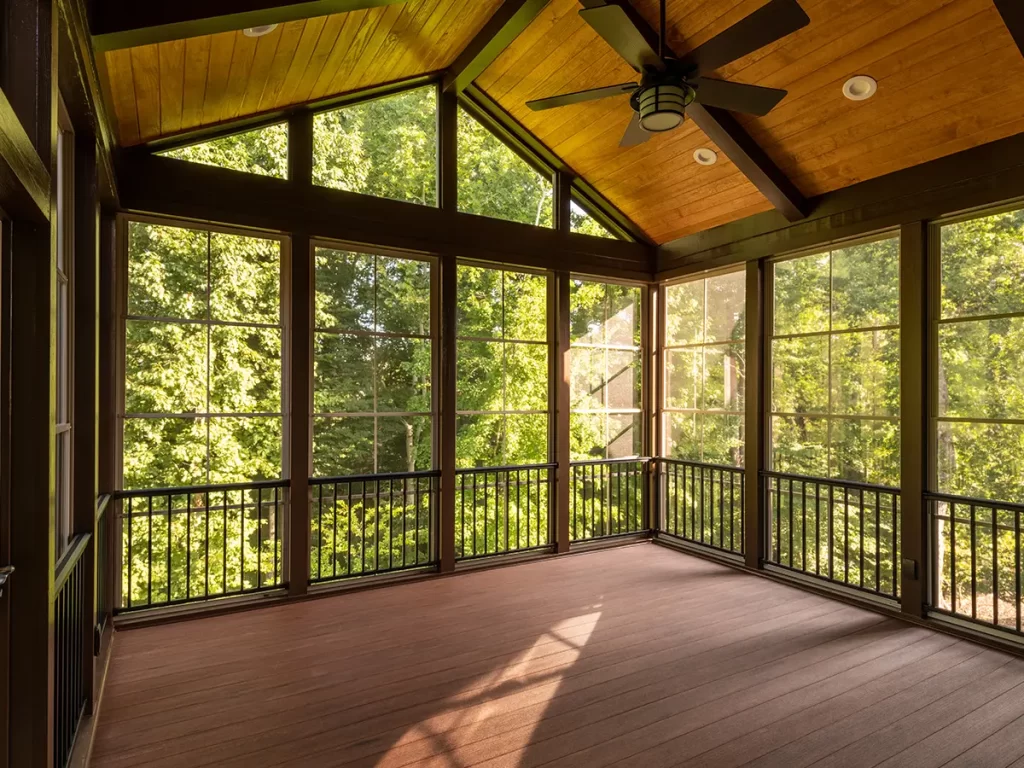 A screened in porch with composite decking, aluminum railing, and screens