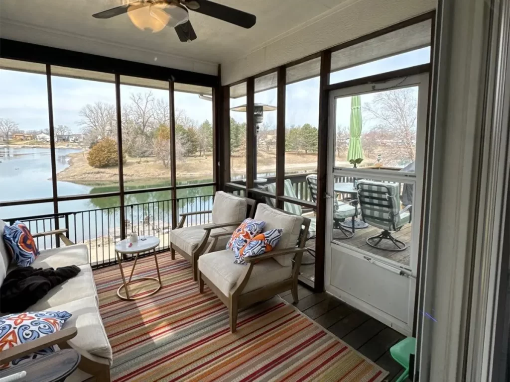 Screened-In Porch in Elkhorn, NE a screened in porch built by Deck Bros in Omaha, with rugs and doutdoor furniture