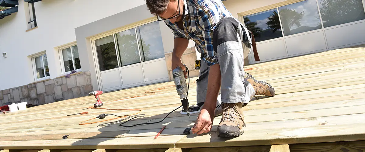 Carpenter installing wooden deck