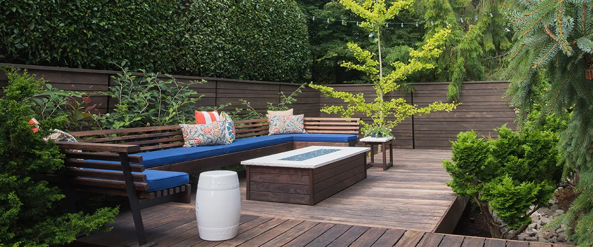 Protect and enhance your deck with Thompson’s Water Seal. This image showcases a stylish backyard retreat with treated wood and vibrant seating.