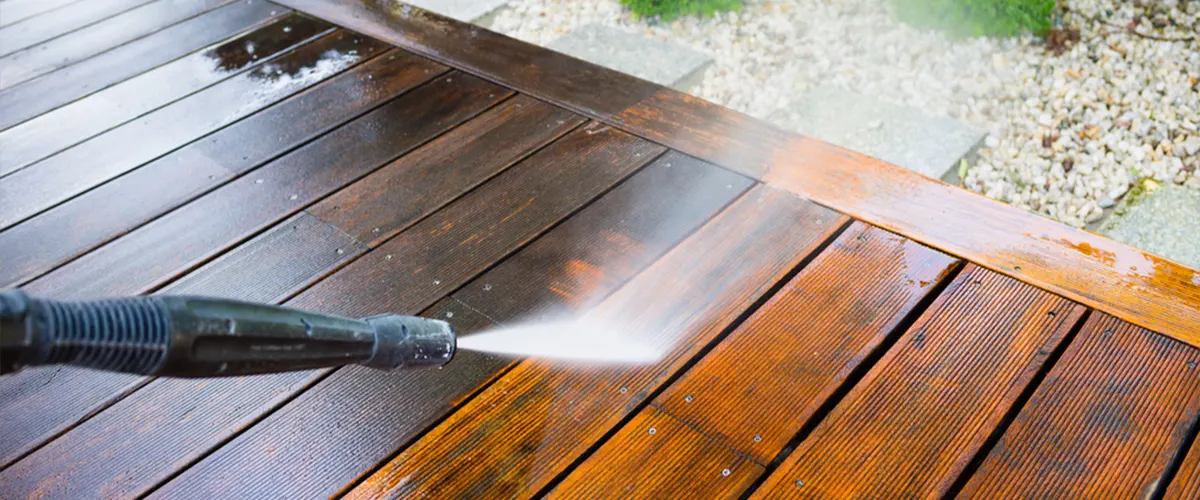 Prepare your deck for Thompson’s Water Seal with proper cleaning techniques. Pictured: a pressure washer restoring a wooden deck's surface.