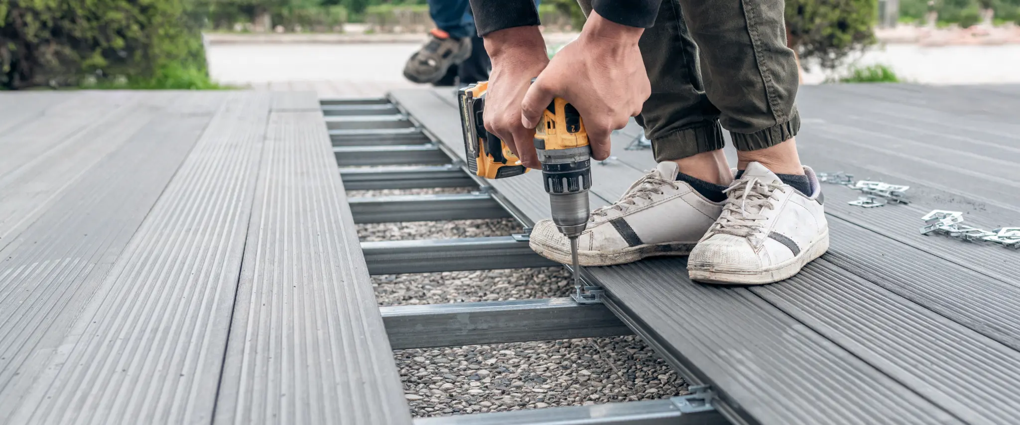 Deck construction with tools and frame being installed on a durable base