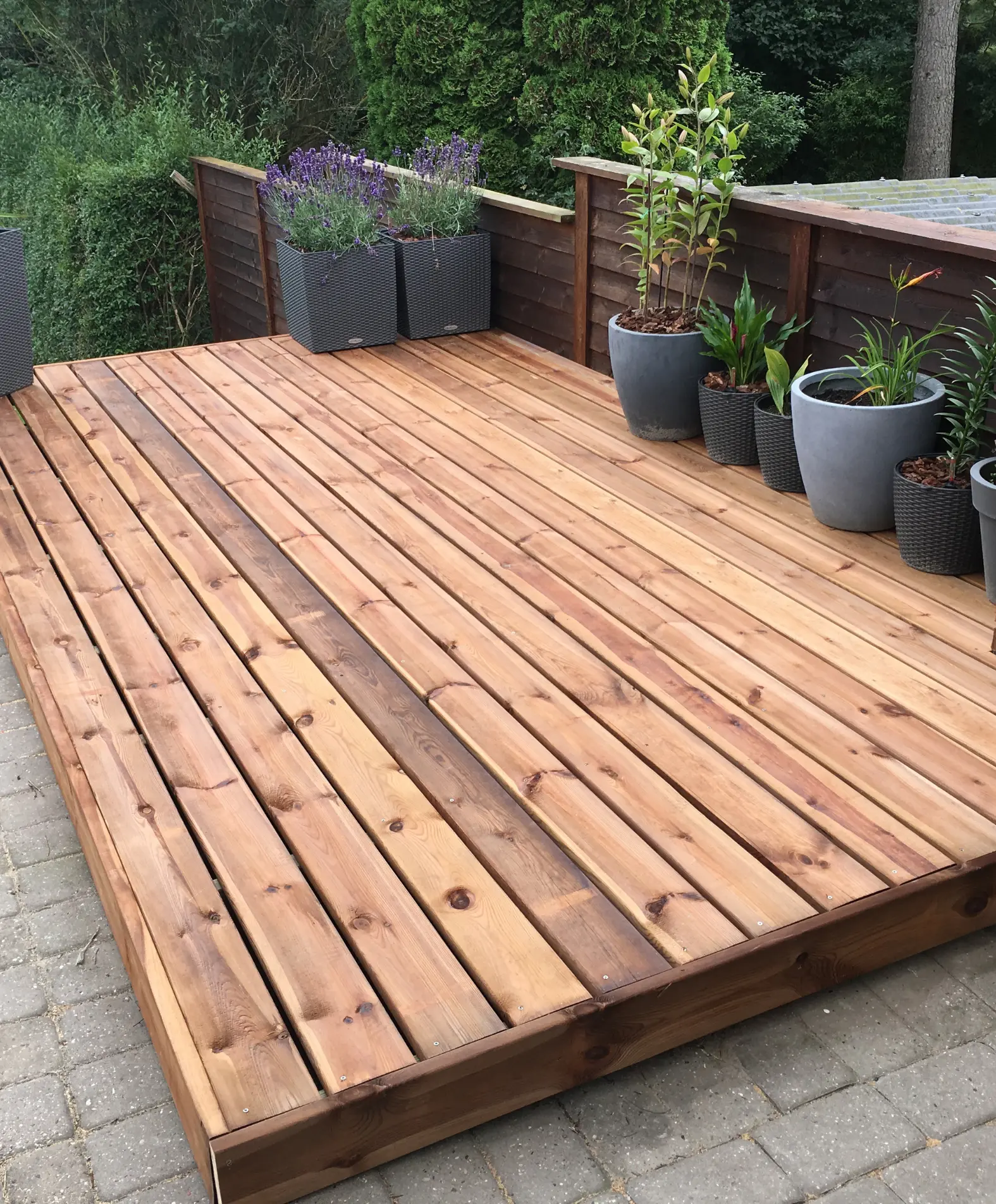 Well-maintained deck with flower planters adding a touch of greenery and charm