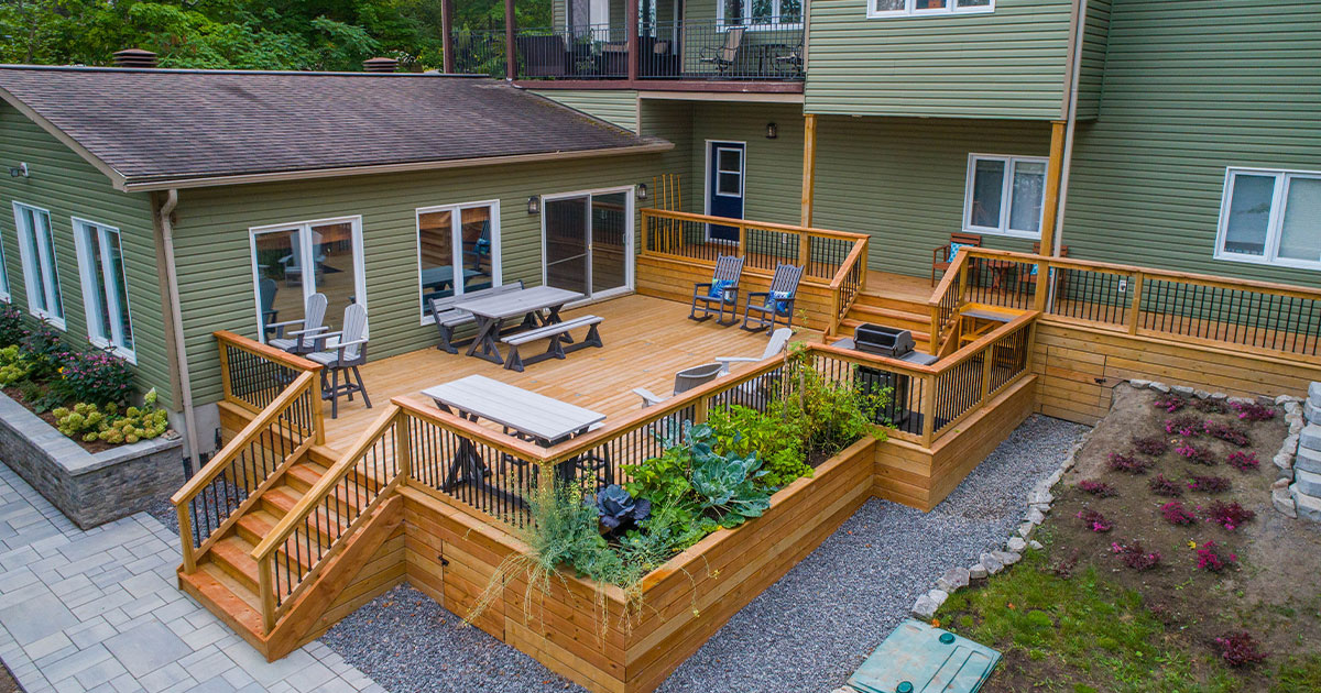 Discover Trex deck problems and solutions with Omaha's deck experts. Pictured: a multi-level wooden deck with built-in planters, railings, and spacious seating areas.