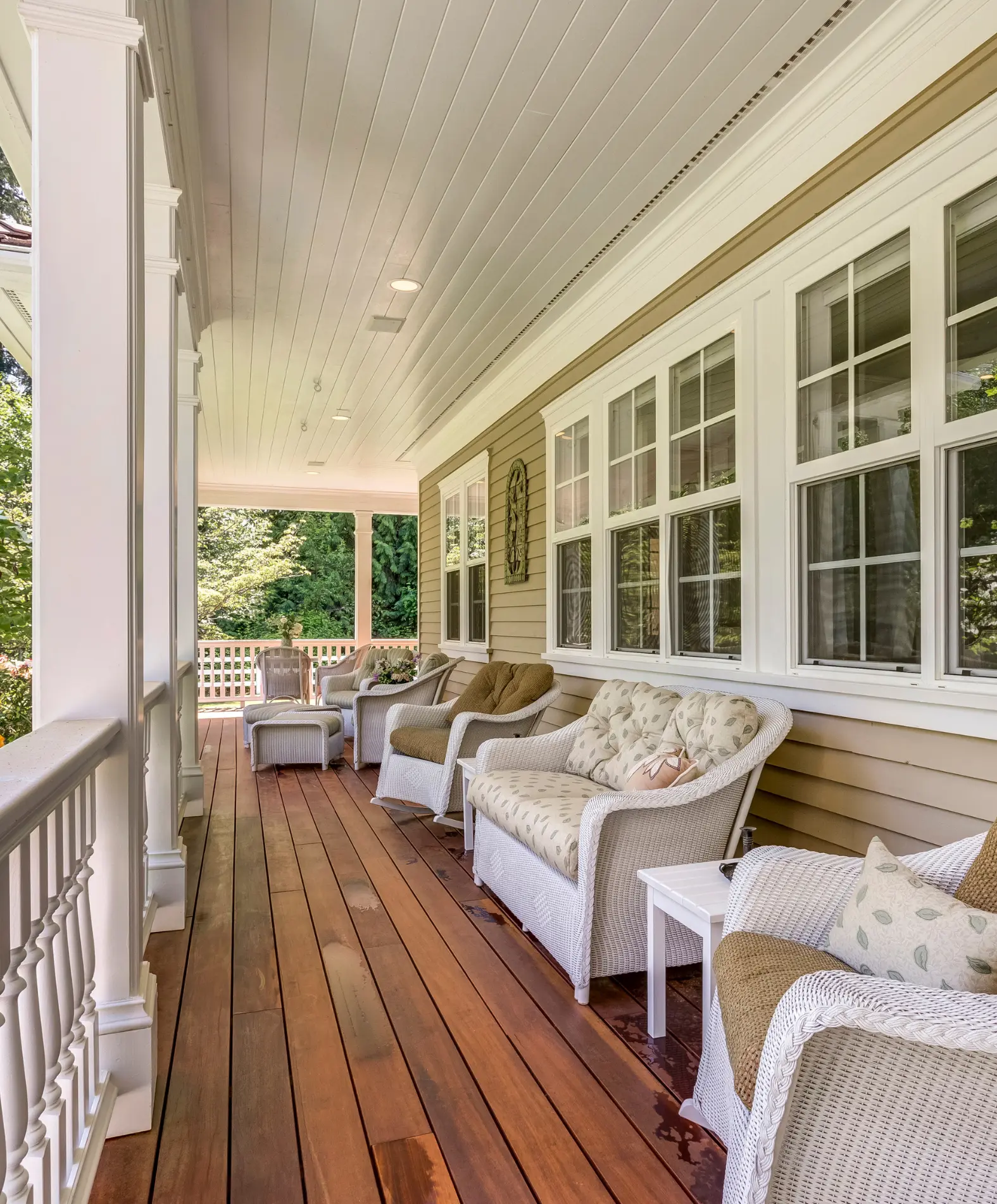 Cozy porch with wooden floor and wicker furniture, perfect for relaxing moments