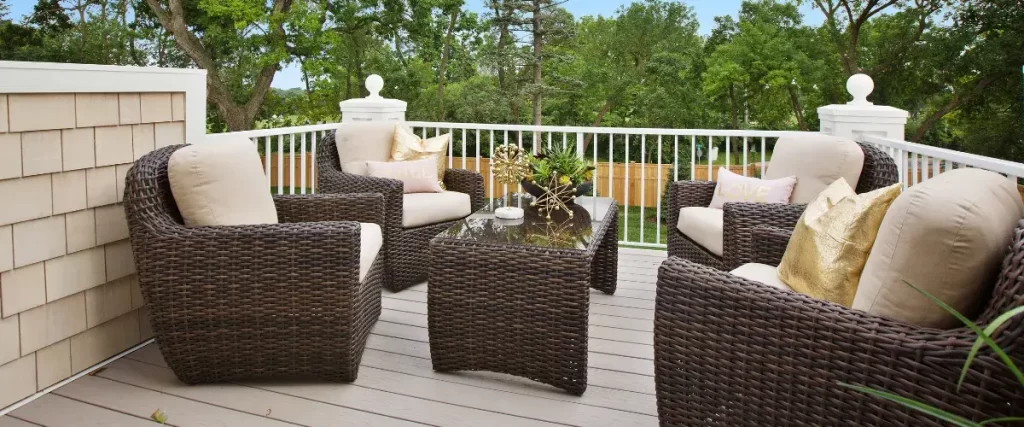 Cozy rooftop deck with wicker furniture and plush cushions, offering a stylish outdoor living space with composite decking.