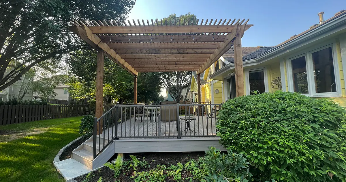 Blog Backyard composite deck with pergola and metal railing for shaded outdoor seating area - featured