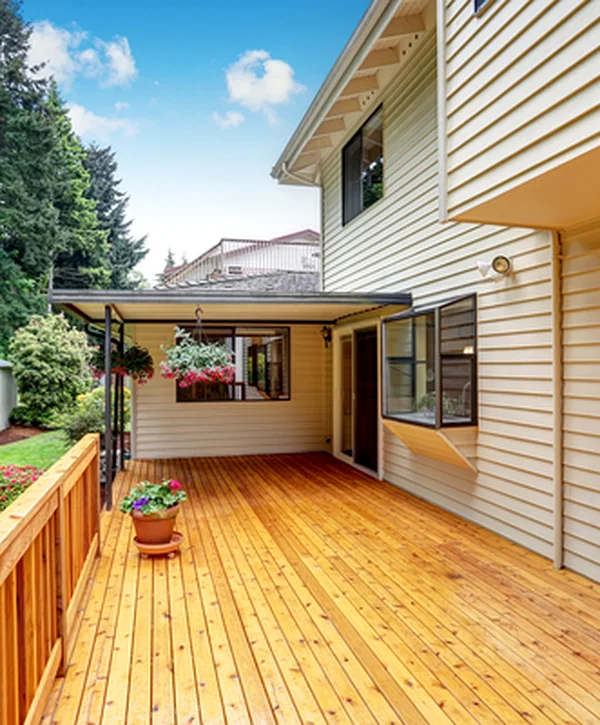 covered deck installation lincoln ne deck building spacious wooden deck with covered area beige siding and landscaped garden