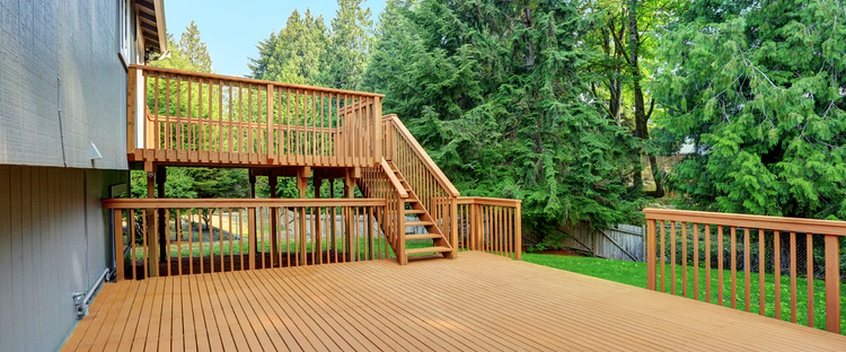 deck installation repair lincoln ne deck building spacious wooden deck with railing surrounded by lush green trees