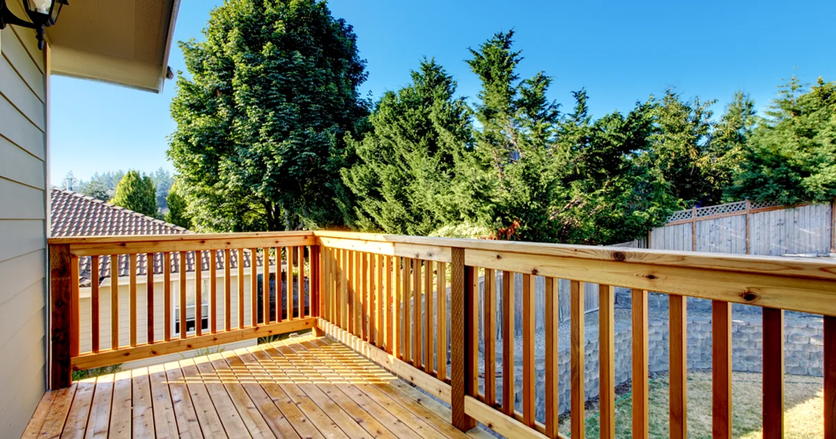 Blog deck maintenance lincoln ne a professionally constructed wooden deck with sturdy railing overlooks lush greenery
