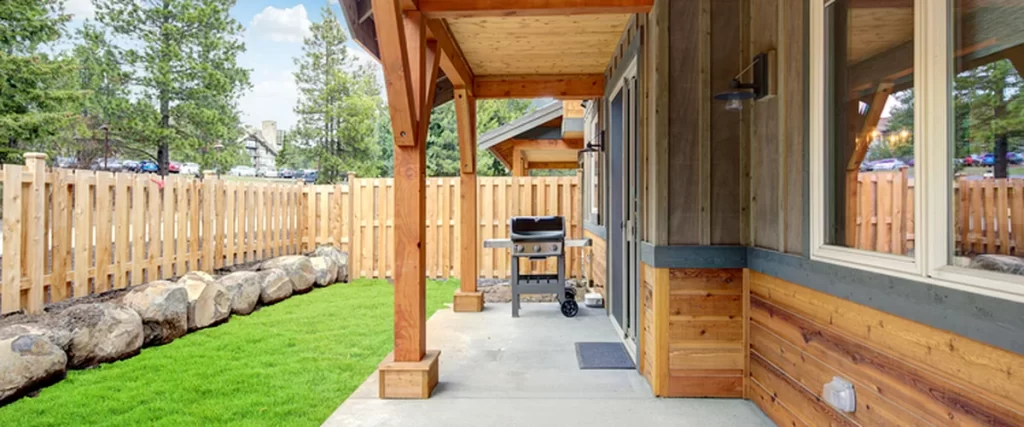 Deck Maintenance in Lincoln: Protecting Your Deck from Sun and Humidity deck maintenance lincoln ne wooden deck with professional grade grill concrete patio cedar fence lush lawn