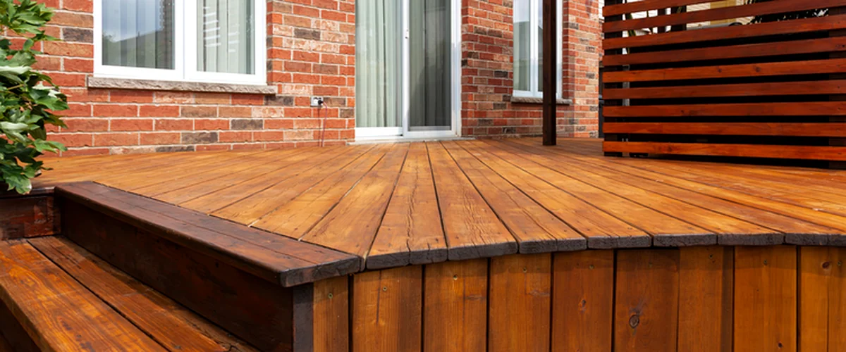 deck staining sealing lincoln ne deck building plaintext expertly stained wooden deck with red brick exterior and privacy screen