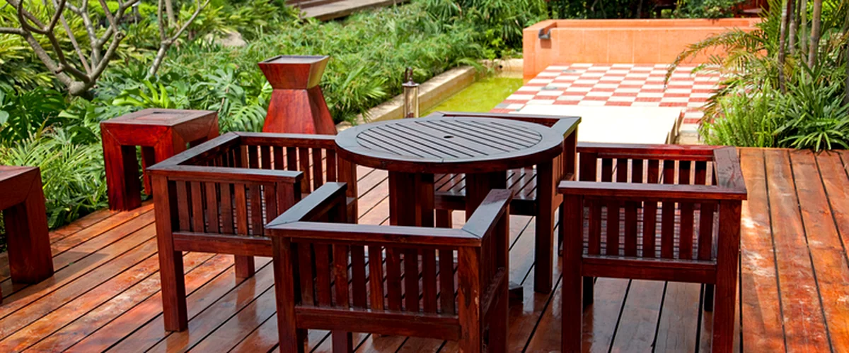 deck staining sealing lincoln ne deck building rich mahogany patio furniture on stained wooden deck amidst lush garden