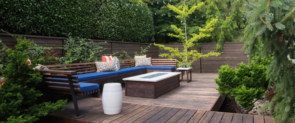 lincoln ne modern outdoor deck with wooden seating blue cushions fire pit lush greenery