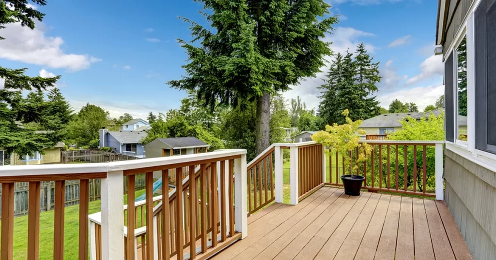 lincoln ne spacious composite deck with professional wood railing overlooking lush backyard
