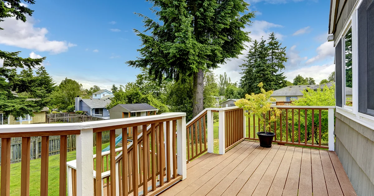 lincoln ne spacious composite deck with professional wood railing overlooking lush backyard