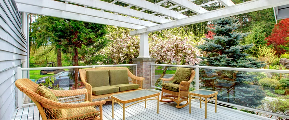 shade structures lincoln ne pergola gazebo building white pergola with glass railing wicker furniture and lush garden view