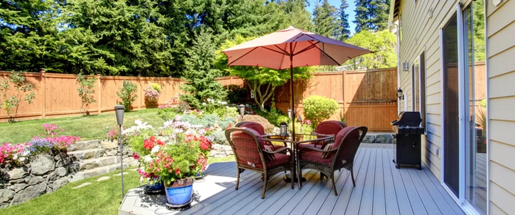 The Best Deck Builders in Lincoln, NE: What to Look For lincoln ne a professional grade gray composite deck with wicker furniture umbrella and vibrant landscaping
