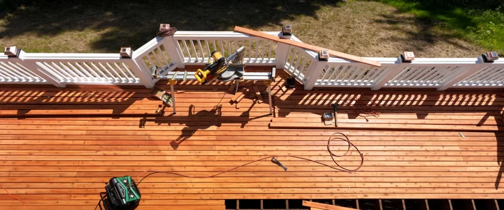 The Best Deck Builders in Lincoln, NE: What to Look For lincoln ne aerial view of contractor quality cedar deck installation with white railings