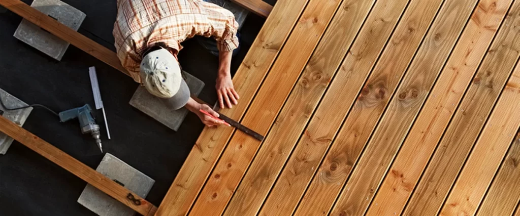 Lincoln Homeowners’ Guide to Preparing Your Deck for Winter lincoln ne professional contractor installing cedar decking boards with precision tools