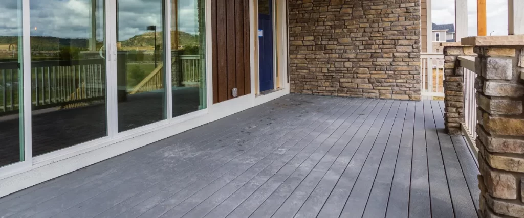 an outdoor deck area featuring composite decking, a material made from a blend of recycled wood fibers and plastics.