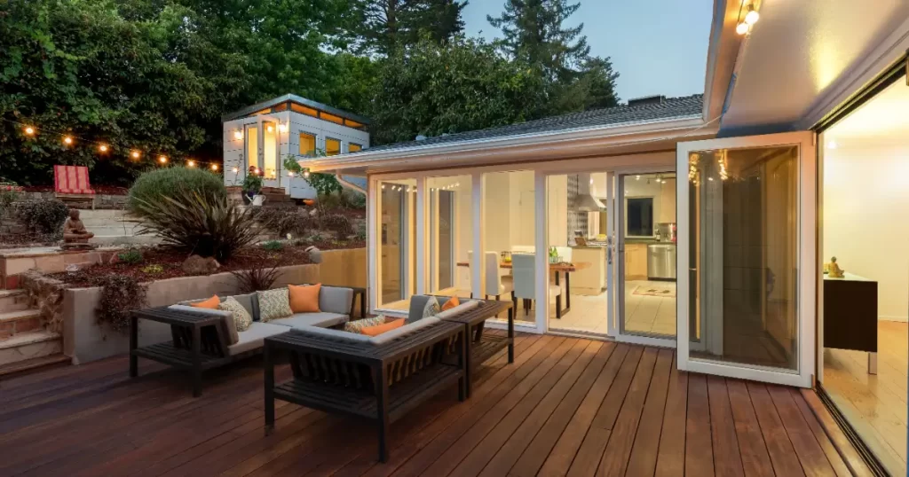 an outdoor wooden deck attached to a modern home